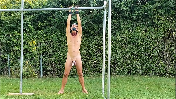naked pathetic slave in penis cage during outdoor party handcuffed, clamps on testicles, lol