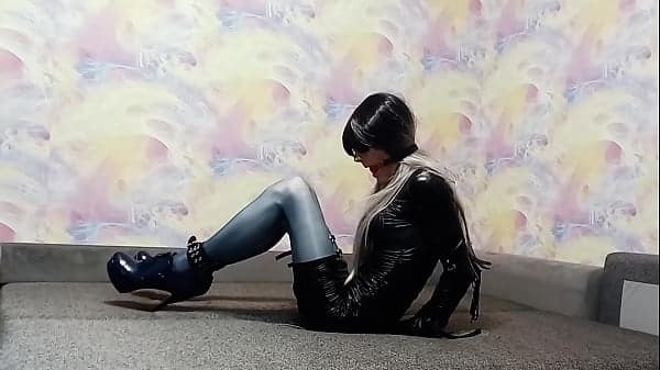 A crossdresser bound in an armbinder and gagged, unable to loosen the bonds